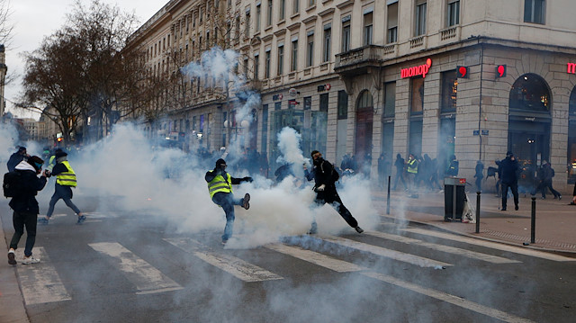 File photo: Protesters throw tear gas canisters back during a demonstration of French labour union members and workers on strike, as France faces its 38th consecutive day of strike against French government's pensions reform plans, in Lyon, France January 11, 2020