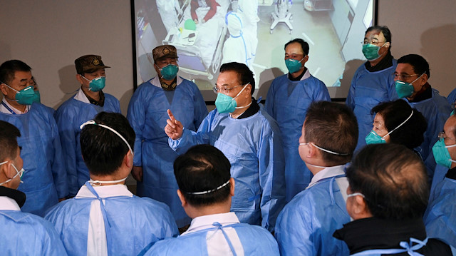 Chinese Premier Li Keqiang wearing a mask and protective suit speaks to medical workers as he visits the Jinyintan hospital where the patients of the new coronavirus are being treated following the outbreak, in Wuhan, Hubei province, China January 27, 2020. cnsphoto via REUTERS. ATTENTION EDITORS - THIS IMAGE WAS PROVIDED BY A THIRD PARTY. CHINA OUT. TPX IMAGES OF THE DAY

