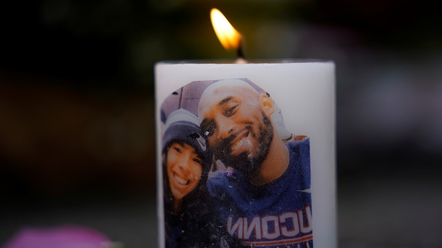 NBA basketball star Kobe Bryant and his daughter Gianna's image are shown on a burning candle as fans pay their respects at a memorial outside the Staples Center at L.A. Live in Los Angeles, California, U.S., January 27, 