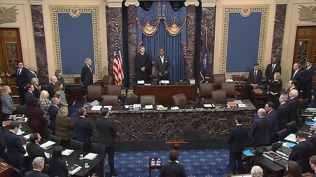 Chief Justice of the United States John Roberts stands with Senate Chaplain retired Rear Adm. Barry Black during an opening prayer at the Senate impeachment trial of U.S. President Donald Trump in this frame grab from video shot in the U.S. Senate Chamber at the U.S. Capitol in Washington, U.S., January 27, 2020