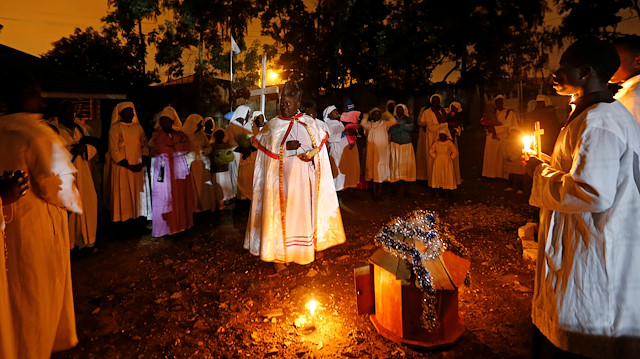 Christian faithful of the Legio Maria African Mission church hold candles as they attend the Christmas eve vigil mass in their church in the Fort Jesus area of Nairobi, Kenya December 25, 2019. REUTERS/Thomas Mukoya

