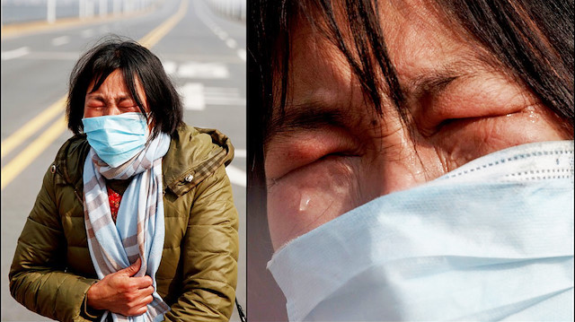 A mother reacts as she pleads with police to allow her daughter to pass a checkpoint for cancer treatment after she arrived from Hubei province at the Jiujiang Yangtze River Bridge in Jiujiang, Jiangxi province, China, as the country is hit by an outbreak of a new coronavirus, February 1, 2020