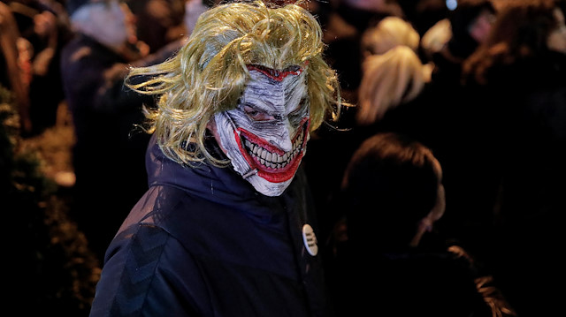 A demonstrator wearing the DC comic Joker character's mask attends a protest against Serbian President Aleksandar Vucic and his government in central Belgrade, Serbia, December 7, 2019. REUTERS/Marko Djurica

