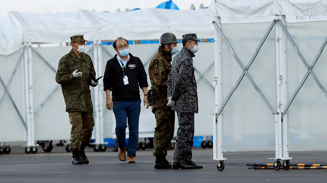 Officers of the Japan Self-Defense Force (JSDF) wearing masks are seen