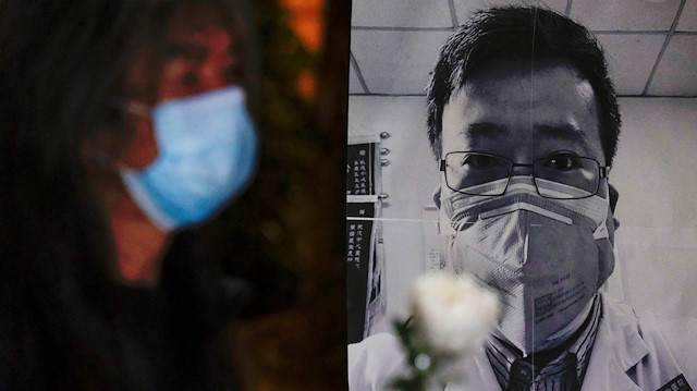 File photo: A person wearing a mask attend a vigil for late Li Wenliang, an ophthalmologist who died of coronavirus at a hospital in Wuhan, in Hong Kong, China February 7, 2020. 