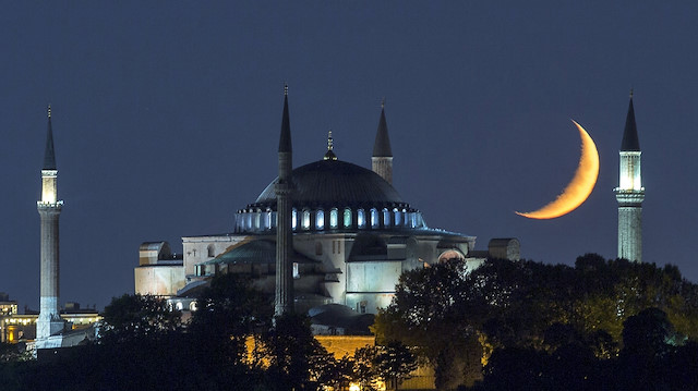 Hagia Sophia at night with crescent moon in the sky in Istanbul, Turkey 