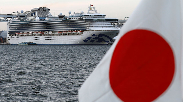 The cruise ship Diamond Princess is seen beside a Japanese flag 