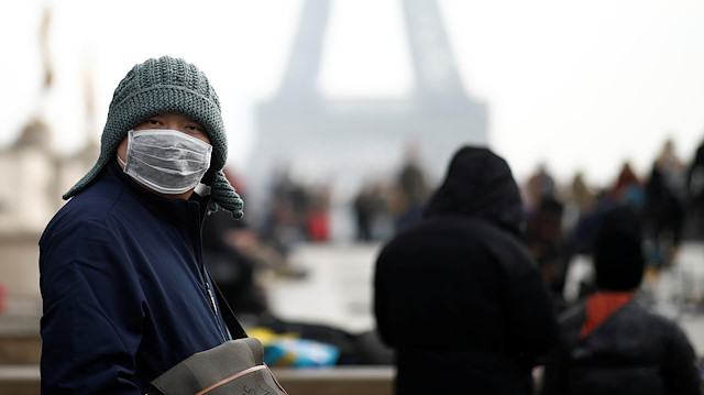 A man wears a face mask on the Trocadero esplanade in front of the Eiffel Tower in Paris, France