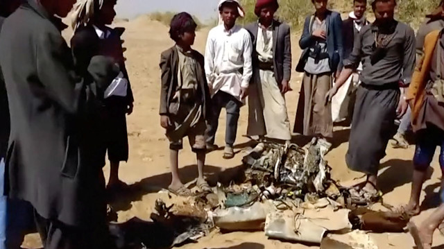 People inspect purported plane crash site in, said to be, Al-Jawf, Yemen 