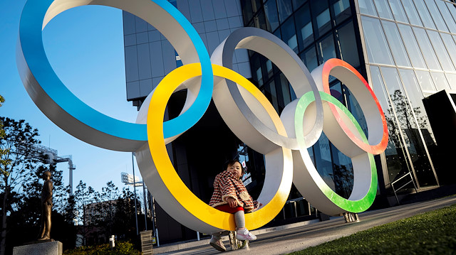 File photo: A child poses for photographs with the Olympic rings in front of the Japan Olympic Museum in Tokyo , Japan, February 17, 2020