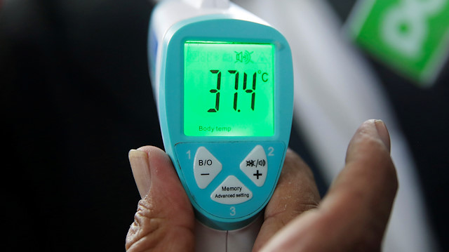 An infrared thermometer shows test temperature dates during a campaign