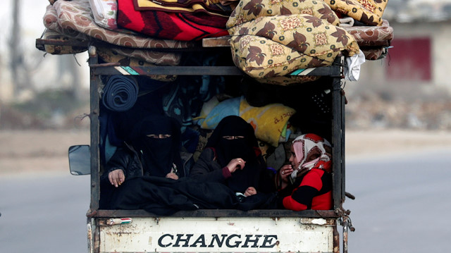 Internally displaced people, who fled from Idlib, ride on a pick up truck with their belongings in Azaz, Syria February 15, 2020. REUTERS/Khalil Ashawi
