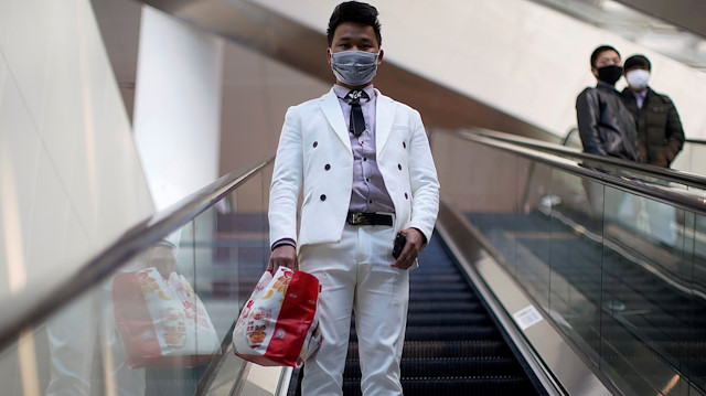 A man wearing a face mask rides an escalator at the Shanghai Hongqiao Railway Station on the last day of the Spring Festival travel rush, as the country is hit by an outbreak of the novel coronavirus, in Shanghai, China February 18, 2020. REUTERS/Aly Song TPX IMAGES OF THE DAY

