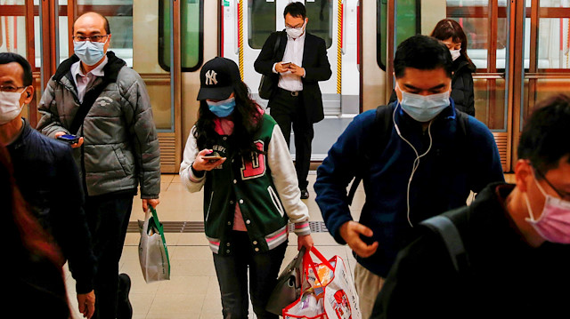 FILE PHOTO: People wear protective masks following the outbreak of a new coronavirus, during their morning commute in a station, in Hong Kong, China February 10, 2020. REUTERS/Tyrone Siu/File Photo

