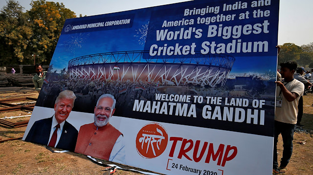 Workers prepare a hoarding with the images of the U.S. President Donald Trump and India's Prime Minister Narendra Modi ahead of Trump's visit, on the outskirts of Ahmedabad, India, February 19, 2020. REUTERS/Amit Dave

