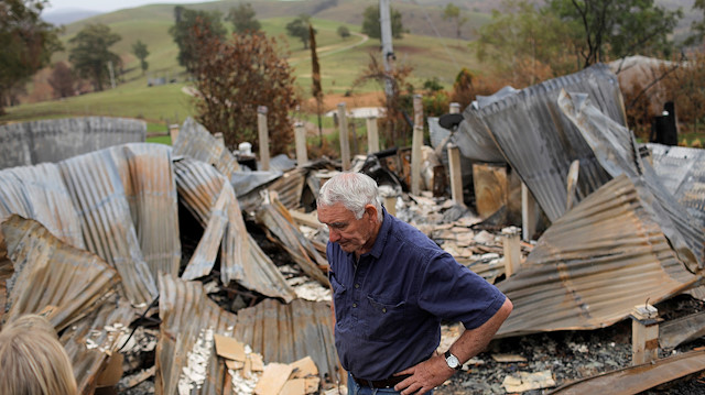 File photo: Farmer Jeff McCole, 70, pauses in front of his family home destroyed by bushfire in Buchan, Victoria, Australia, January 23, 2020. 