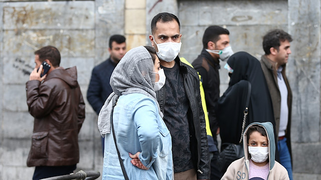 Iranian family wear protective masks to prevent contracting a coronavirus, as they stand at Grand Bazaar in Tehran, Iran February 20, 2020. 