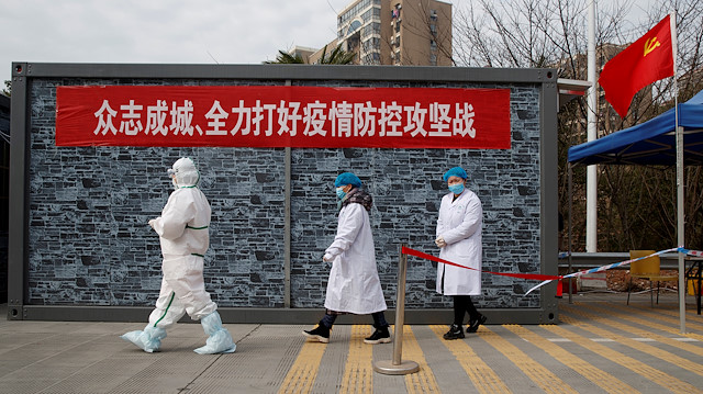 Hospital staff in protective garments walk at a checkpoint to the Hubei province exclusion zone at the Jiujiang Yangtze River Bridge in Jiujiang, Jiangxi province, China, as the country is hit by an outbreak of a new coronavirus, February 1, 2020.