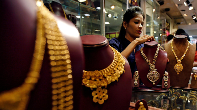 FILE PHOTO: A salesperson attends to a customer (not pictured) inside a jewellery showroom, during Akshaya Tritiya, a major gold-buying festival, in Mumbai, India April 28, 2017