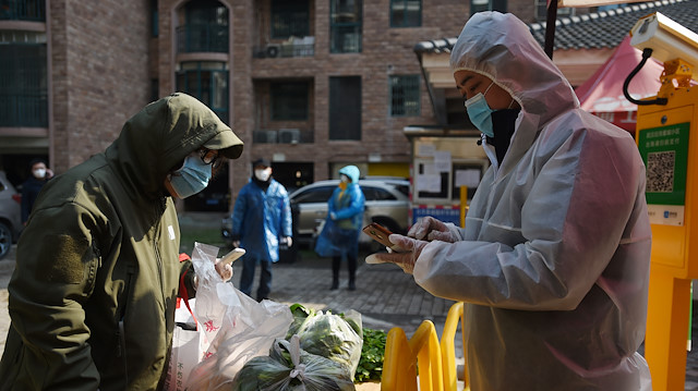 File photo: A resident collects vegetables purchased through group orders at the entrance of a residential compound in Wuhan, the epicentre of the novel coronavirus outbreak, Hubei province, China February 21, 2020