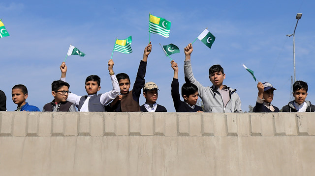 Students wave Azad KashmirÕs and national flags, during a walk to mark Kashmir Solidarity Day
