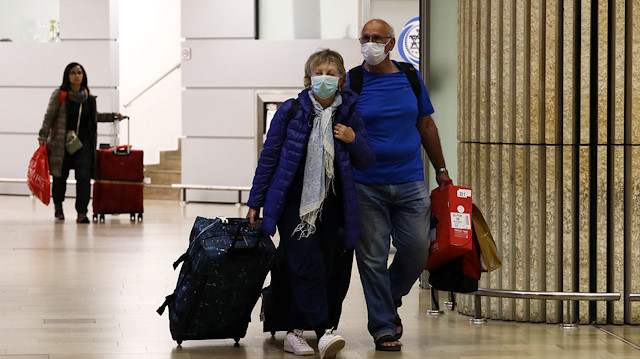 Passengers walk at the arrival area of a terminal at the Ben Gurion airport in Lod