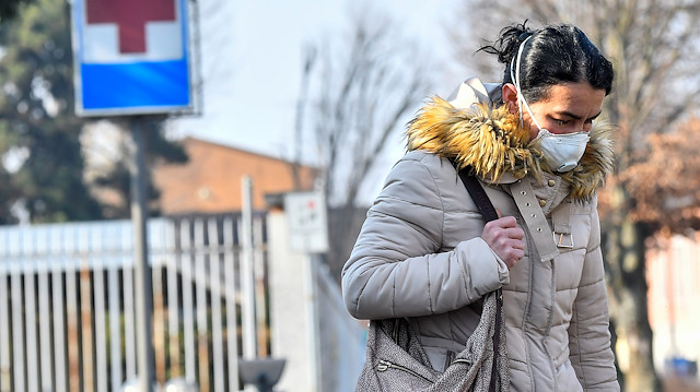 A woman wearing a face mask leaves the hospital of Codogno amid a coronavirus outbreak