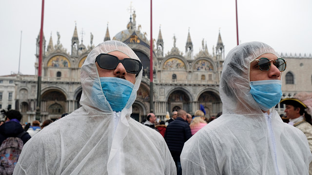 File photo: Tourists wear protective face masks at Venice Carnival, which the last two days of, as well as Sunday night's festivities, have been cancelled because of an outbreak of coronavirus, in Venice, Italy February 23, 2020. 