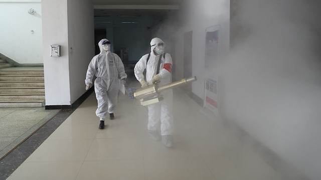 File photo: Volunteers in protective suits disinfect a residential compound in Wuhan, the epicentre of the novel coronavirus outbreak, in Hubei province, China February 22, 2020. Picture taken February 22, 2020