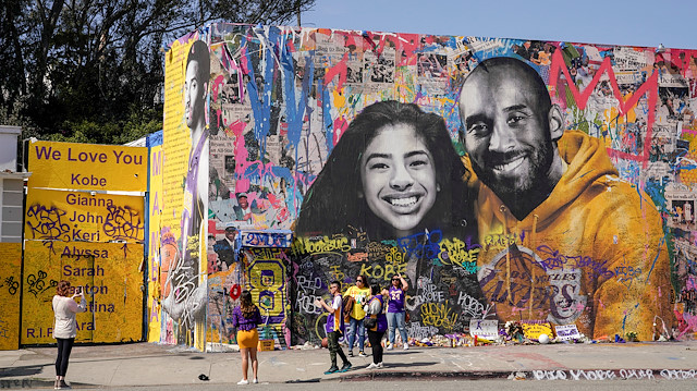 Fans gather around a mural of late NBA great Kobe Bryant and his daughter Gianna Bryant during a public memorial for them and seven others killed in a helicopter crash, at the Staples Center in Los Angeles, California, U.S., February 24, 2020