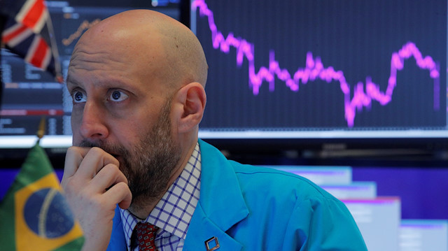 File photo: Specialist trader works at his post on the floor at the New York Stock Exchange (NYSE) in New York, U.S., February 24, 2020
