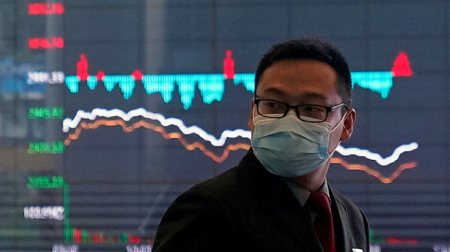 A man wearing a protective mask is seen inside the Shanghai Stock Exchange 