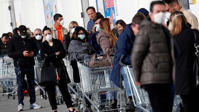 FILE PHOTO: People queue at a supermarket outside the town of Casalpusterlengo, which has been closed by the Italian government due to a coronavirus outbreak in northern Italy, February 23, 