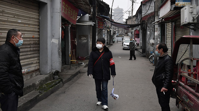 File photo: People wearing masks are seen in an alley near the Yellow Crane Tower in Wuhan, the epicentre of the novel coronavirus outbreak, Hubei province, China February 27, 2020