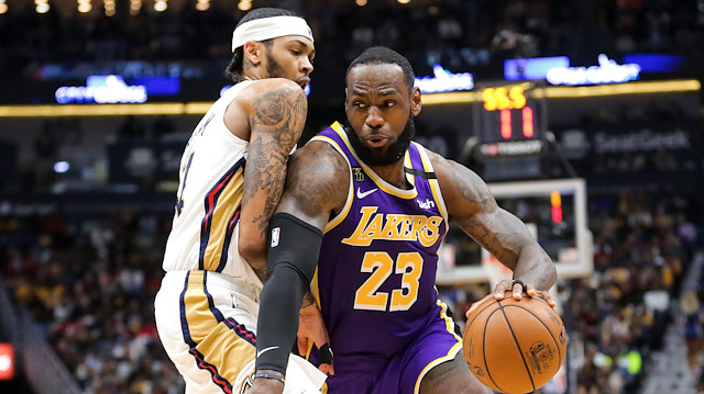 Mar 1, 2020; New Orleans, Louisiana, USA; Los Angeles Lakers forward LeBron James (23) drives past New Orleans Pelicans forward Brandon Ingram (14) during the second quarter at the Smoothie King Center. Mandatory Credit: Derick E. Hingle-USA TODAY Sports


