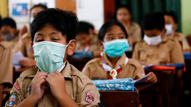 File photo: Students wear protective masks in school after Indonesia confirmed its first cases of COVID-19, in Jakarta, Indonesia, March 4, 2020