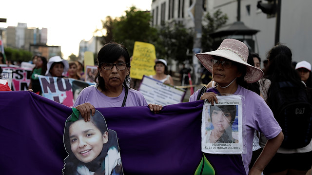 Relatives of missing persons hold pictures of their loved ones during a march to mark International Women's Day in Lima, Peru March 7, 2020