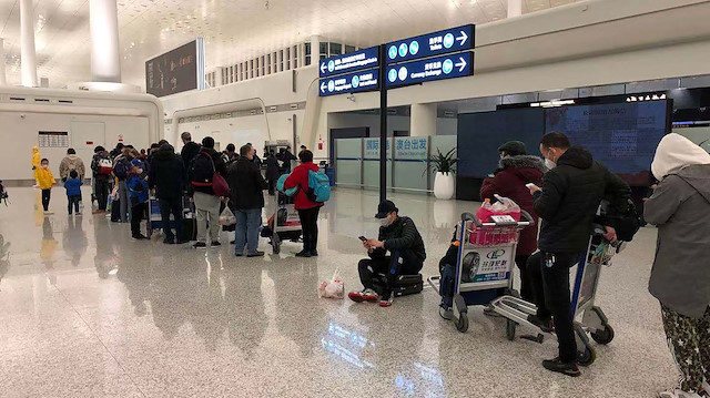 File photo: Passengers queue to board a cargo plane, chartered by the U.S. State Department to evacuate Americans and Canadians from China due to the outbreak of novel Coronavirus, at Wuhan Tianhe International Airport in Wuhan, China