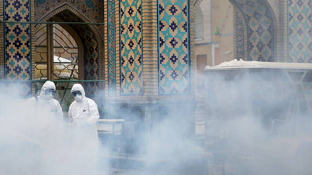 FILE PHOTO: Members of the medical team spray disinfectant to sanitize outdoor place of Imam Reza's holy shrine, following the coronavirus outbreak, in Mashhad, Iran February 27