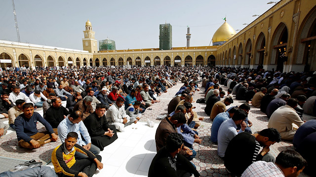 Muslim pilgrims sit during Friday prayers, following the coronavirus outbreak, at the Kufa mosque in Najaf, Iraq March 6, 2020
