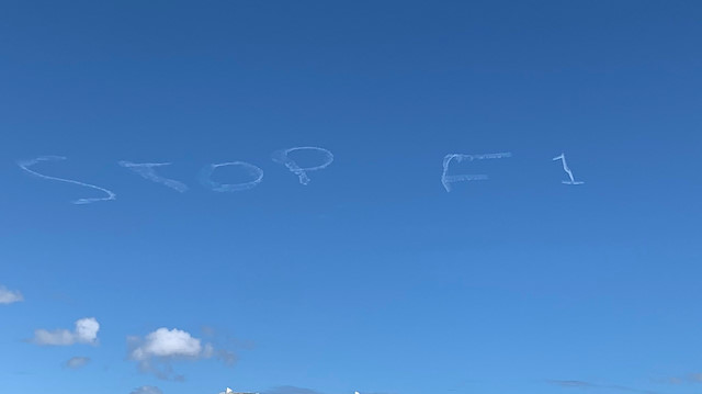 Skywriting in the sky which reads "Stop F1" in white smoke is seen in Sydney, Australia in this March 11, 2020 picture obtained from social media. MIKE SEARLE /via REUTERS 