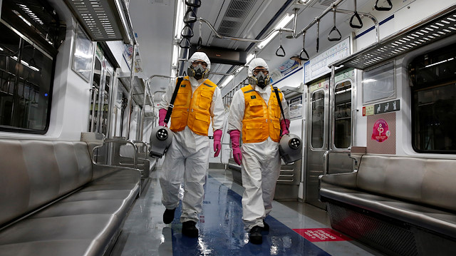 File photo: Employees from a disinfection service company sanitize a subway car depot amid coronavirus fears in Seoul, South Korea, March 11, 2020. 
