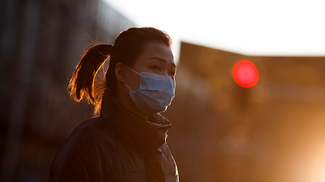 File photo: A woman wears a mask during evening rush hour as the country is hit by the outbreak of the novel coronavirus in Beijing, China, March 10, 2020. 