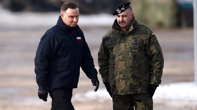 Poland's President Andrzej Duda (L) walks past general Jaroslaw Mika 