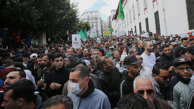 A demonstrator wearing a face mask marches with others during an anti-government protest, following the coronavirus outbreak, in Algiers, Algeria March 6, 2020.