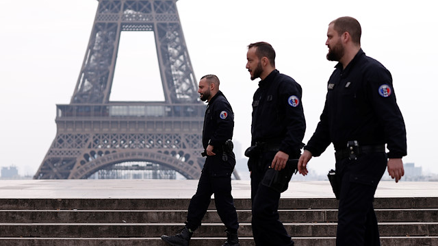 French police patrol at the Tocadero square near the Eiffel tower in Paris as a lockdown imposed to slow the rate of the coronavirus disease (COVID-19) contagion started at midday in France