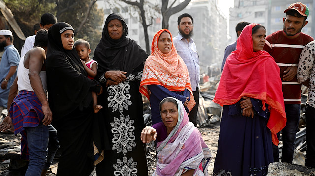 A woman reacts after a fire broke out in a slum in Dhaka, Bangladesh, March 11, 2020.