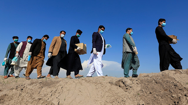 Members of civil society activists, distribute face masks to the villagers during a campaign spreading the awareness of the coronavirus disease (COVID-19), in Nangarhar province, Afghanistan March 18, 2020. 
