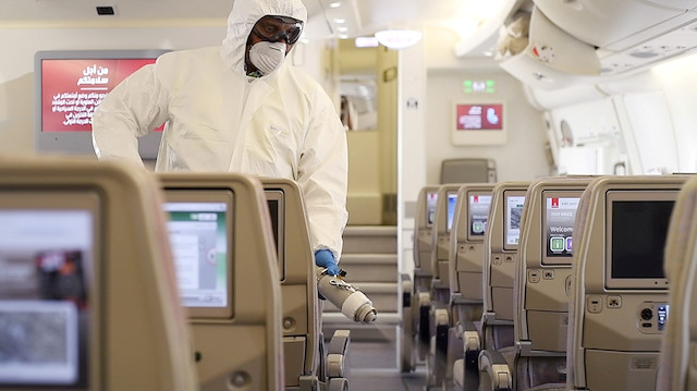 File photo,: A member of cleaning staff in protective suit disinfects the cabin of an Emirates Airbus A380, following the outbreak of the coronavirus, in Dubai, United Arab Emirates March 5, 2020