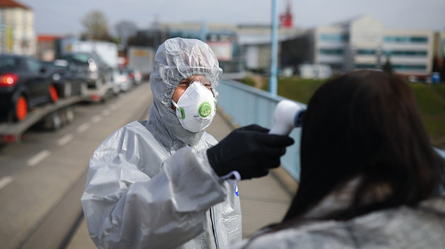 File photo: A woman gets a temperature check on the Poland-German border crossing point during the spread of coronavirus disease (COVID-19) on the city bridge to Slubice, Poland in Frankfurt/Oder, Germany March 19, 2020